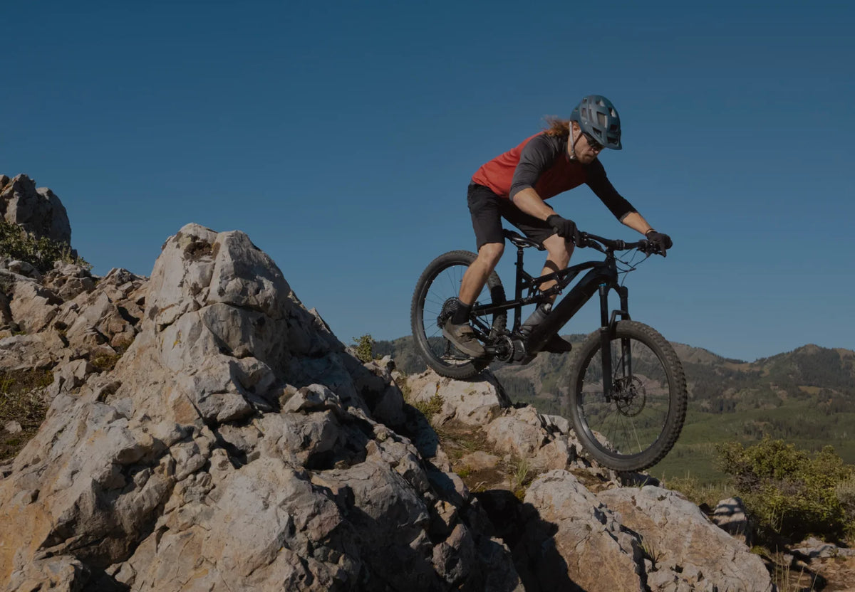 A mountain biker descending a rocky trail